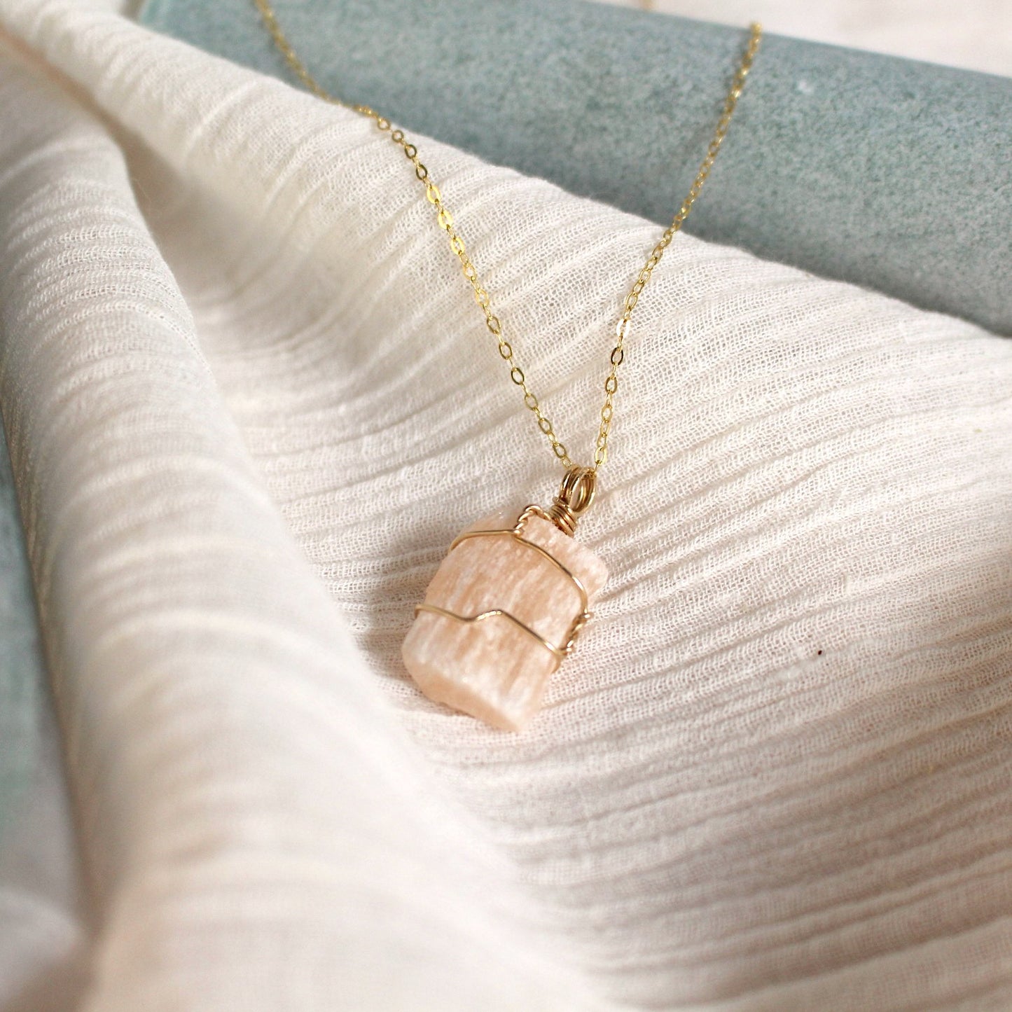 selenite protection charm necklace in 14K gold.